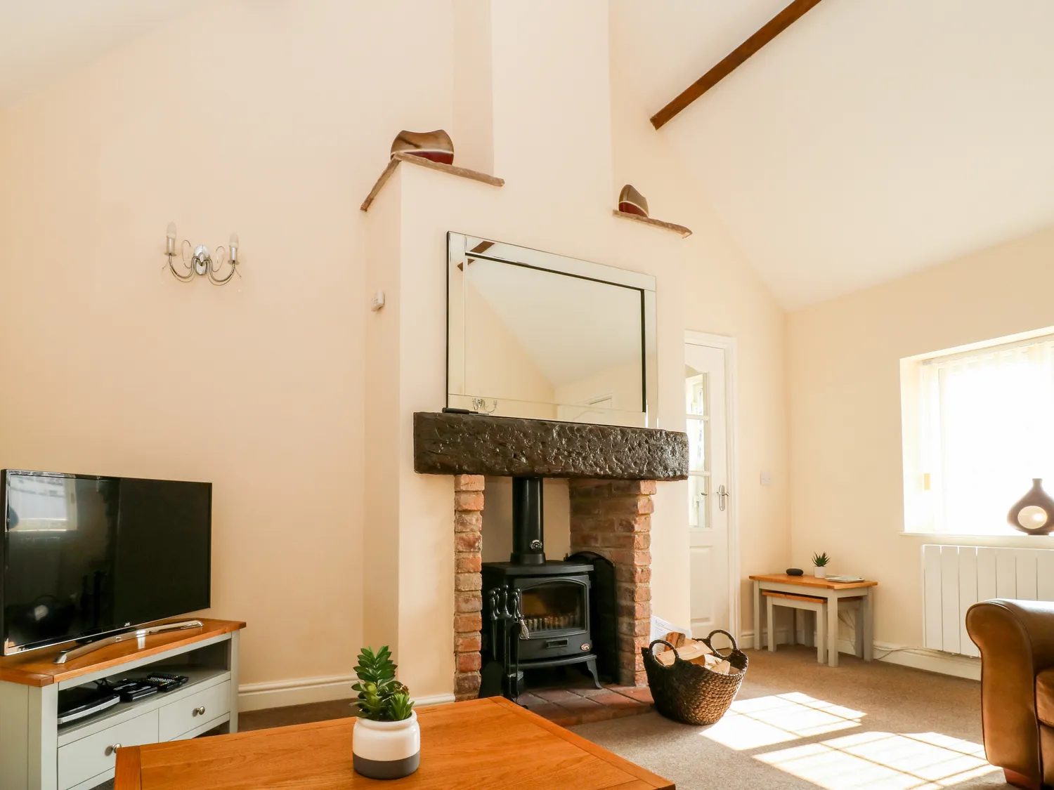 The sitting room with the log burner in its brick fireplace
