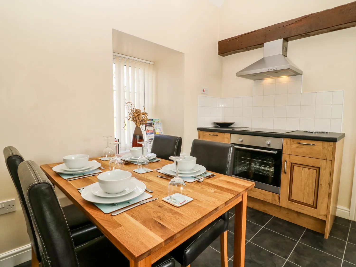 The dining table set for four in the kitchen
