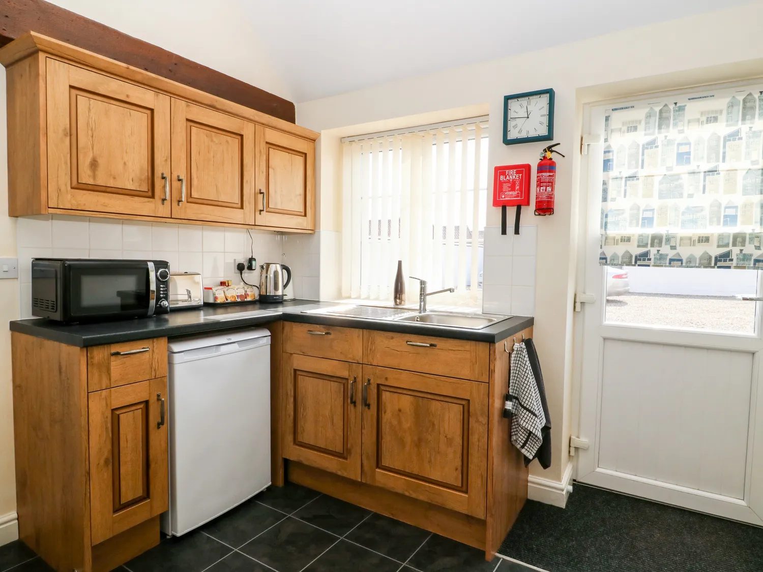 The kitchen with wooden cabinets and sink