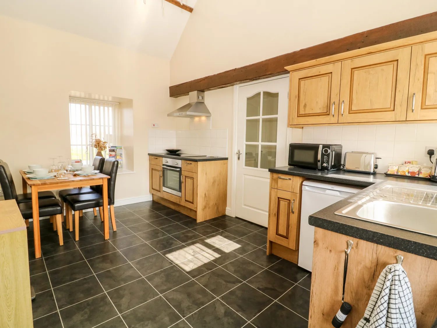 The kitchen and dining area under a timber beam